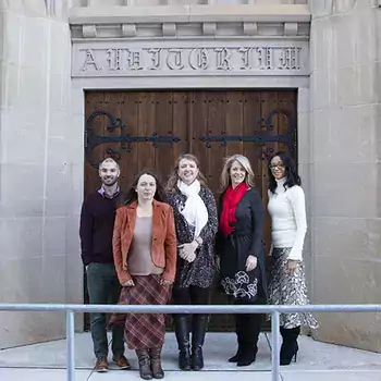 College Advancement staff standing in front of the Ivy Building front doors