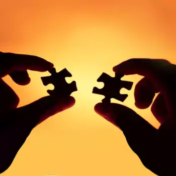 Hands holding two pieces of a puzzle.