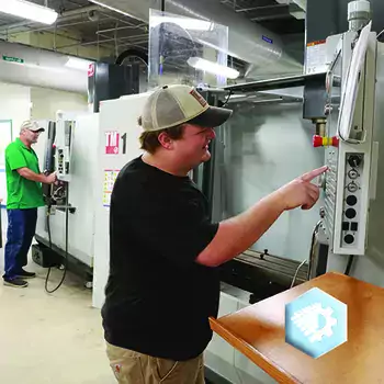 CNC Student with CNC machine in advanced manufacturing