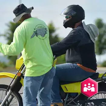 Instructor with student on motorcycle