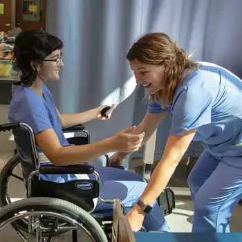 2 Nursing Students working with wheelchair