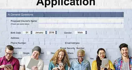 Student Loan Application with students filling out paper work on laptops and tablets