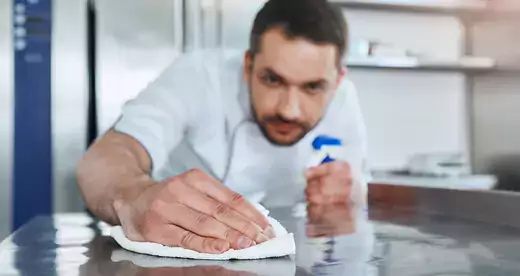 Man cleaning counter top
