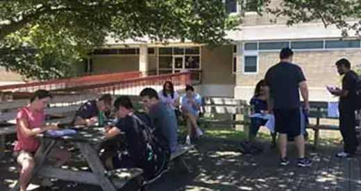Students working on calculus problems on the Beech Tree Deck