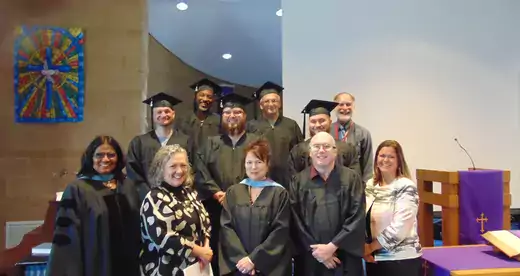 A group of Craggy graduates standing on stairs