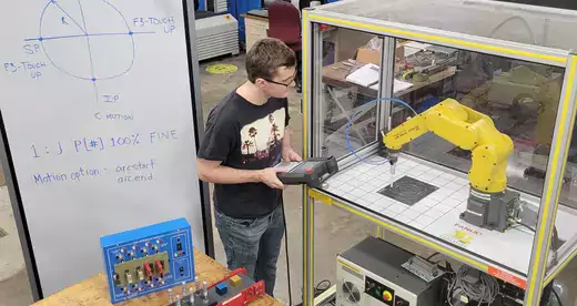 Students using robot arm