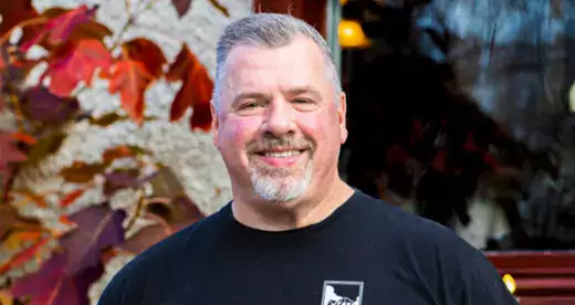 Smiling man wearing black shirt