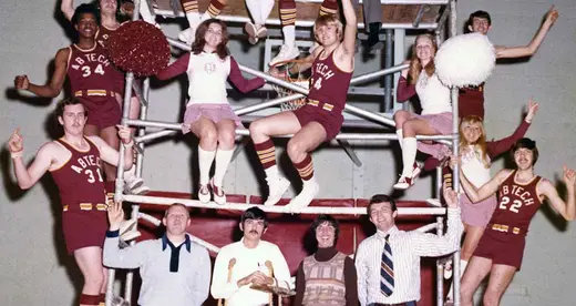 Basketball players and cheerleaders on scaffolding