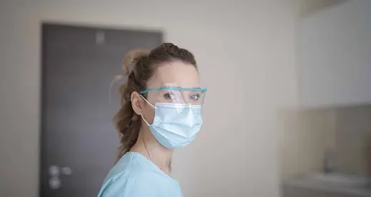 Woman wearing a mask and safety glasses