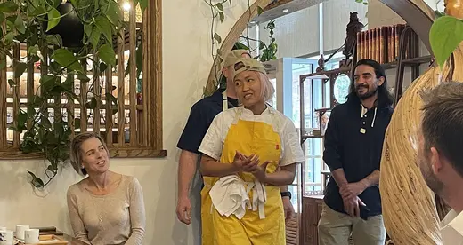 Woman in yellow apron in restaurant