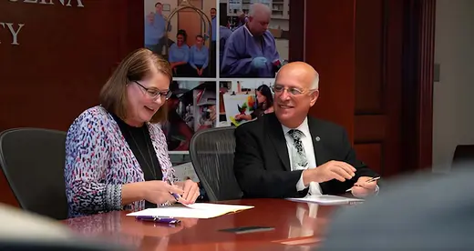 Kelli Brown and Dennis King signing WCU admission agreement