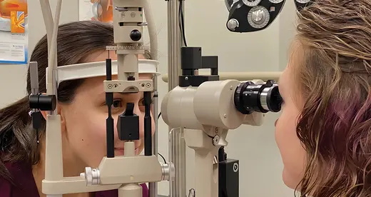 An ophthalmic student checking a patient