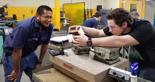 Two men working on a machine