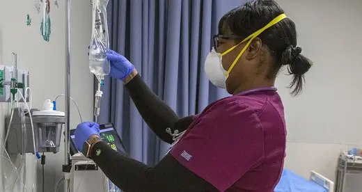 Nursing student checking IV bags