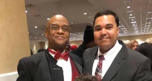 Joe Fox and Brandon Priester standing in auditorium