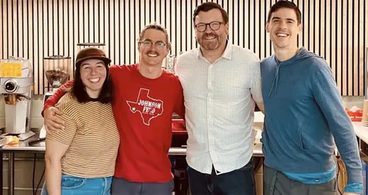 Employees smiling at cafe.