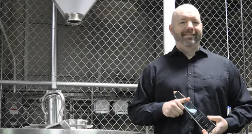 Jeff Irvin holding a Paragon Award