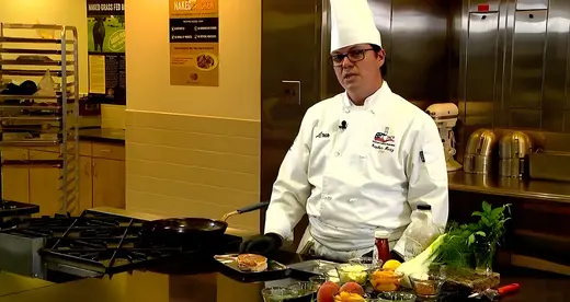 Chef standing behind a counter