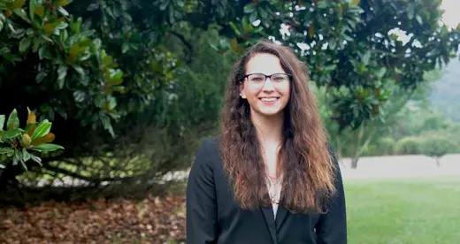 Woman standing next to a tree