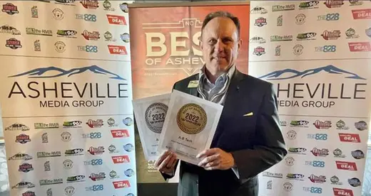 John Gossett holding two awards