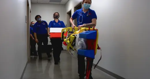 EMS students with equipment in a hallway