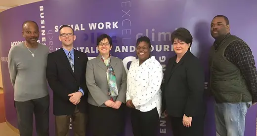 Six men and women standing together