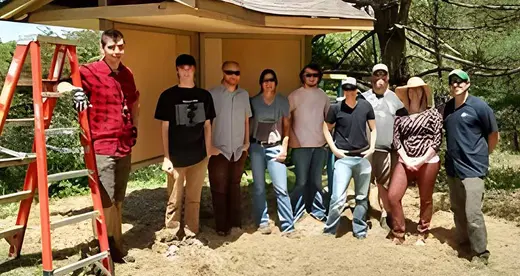Construction I standing in front of a kiosk outdoors.