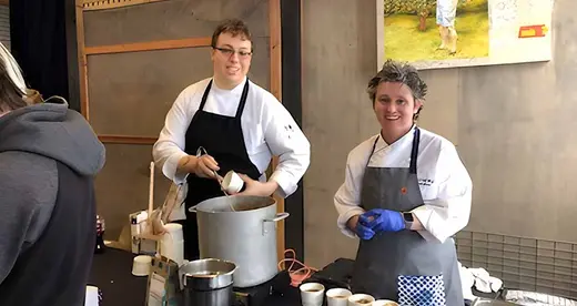Two chefs behind a table