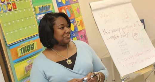 Woman teaching at board