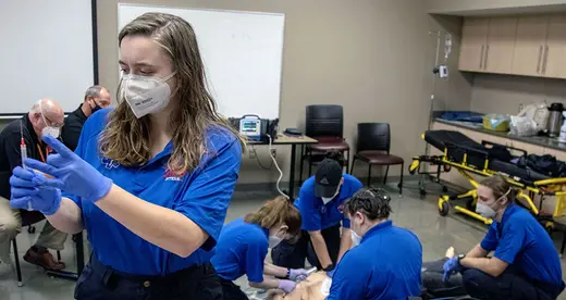 EMS students working on mannequin in the classroom.