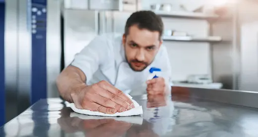 Man cleaning counter top