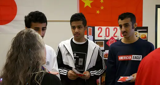 3 men and a woman at a booth