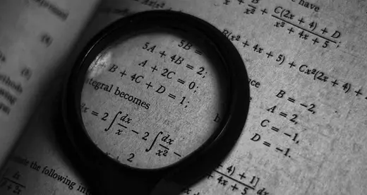 Magnifying glass on a math textbook