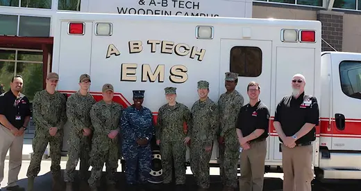 10 men and women standing in front of A-B Tech ambulance