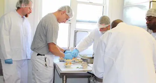 Four men working in a kitchen