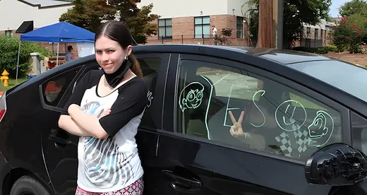 Gabriella Kusz stands next to her mother's car