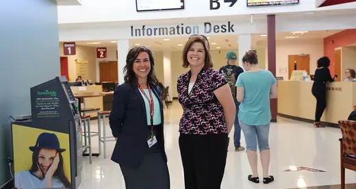 Jenna Deal and Heather Pack standing in the lobby of the Bailey Building.