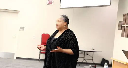 Jacqueline Whittenburg standing in front of room