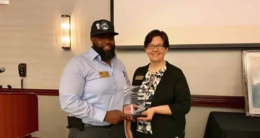 Philip Cooper and Shelley White holding CCA Award