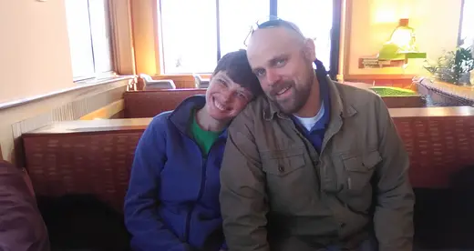 Man and women sitting close together smiling