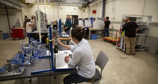 Person working at a station in a laboratory