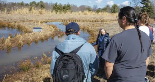 Helen Burrell and students at retention pond