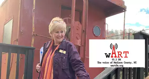 Woman standing in front of a train caboose