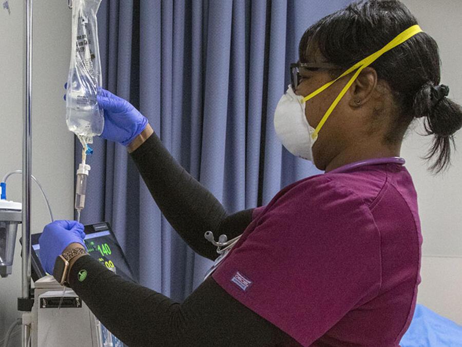 Nursing student checking IV bags