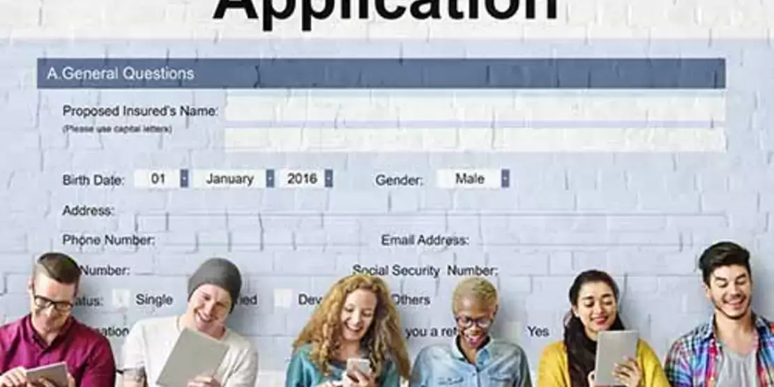 Student Loan Application with students filling out paper work on laptops and tablets