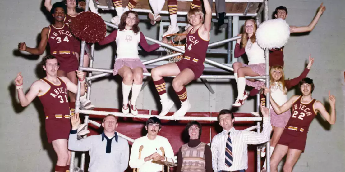 Basketball players and cheerleaders on scaffolding