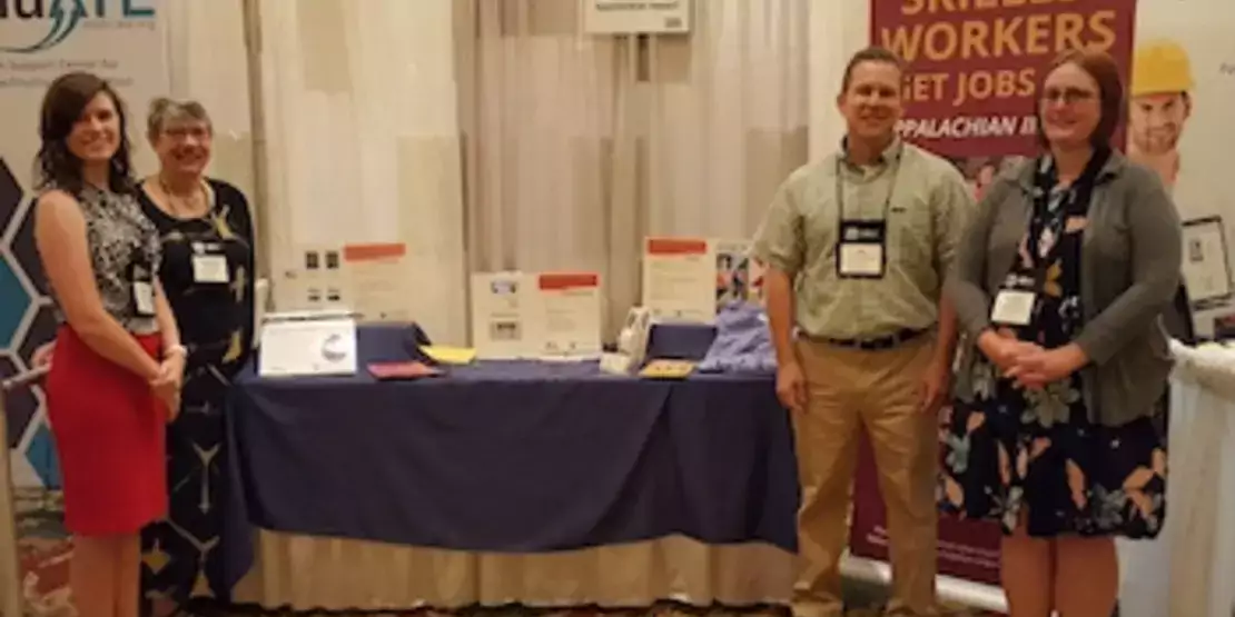 Pictured, from left, are Amanda Whitt, Pamela Silvers, Jim Sullivan and Rachael Tipton in front of a display table.