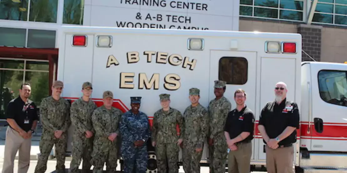 10 men and women standing in front of A-B Tech ambulance