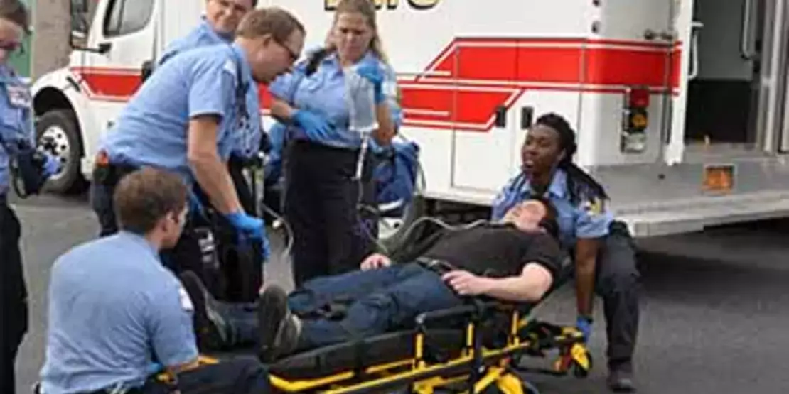 EMS students in front of an ambulance.