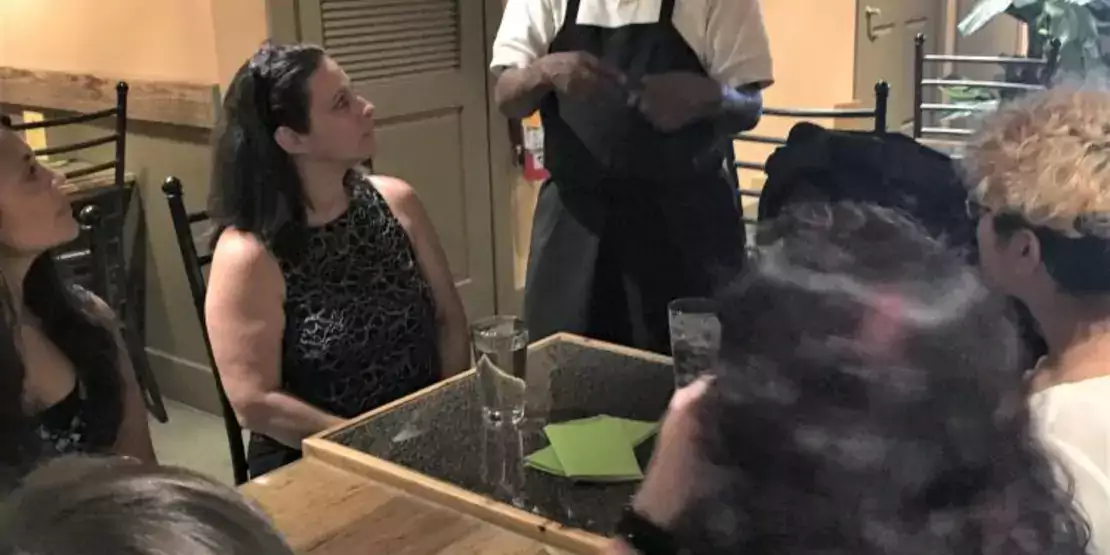 Chef talking to a group of people at a table